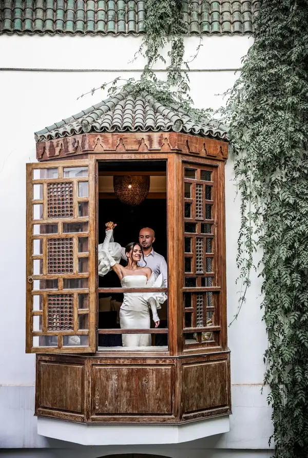 Bride and groom at traditional Moroccan window balcony riad - photographer marrakech