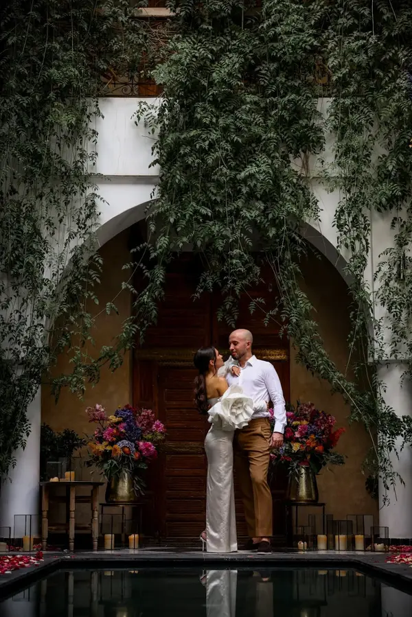 Couple portrait in riad courtyard with greenery and candles - couple photoshoot marrakech